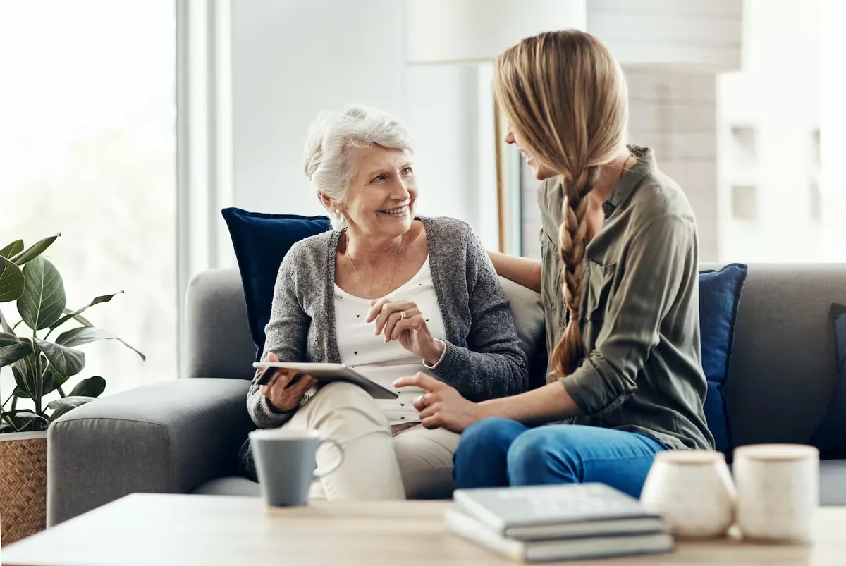 An adviser going through a list with an elderly woman